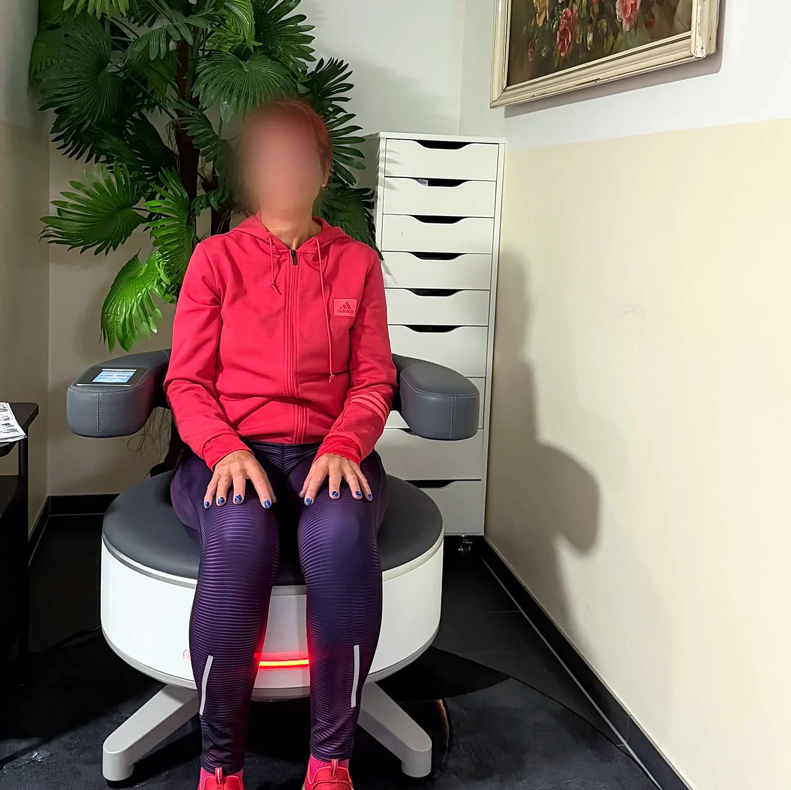 Kundin sitzt in Sportkleidung auf dem BetterPelvi-Trainingsstuhl im Studio